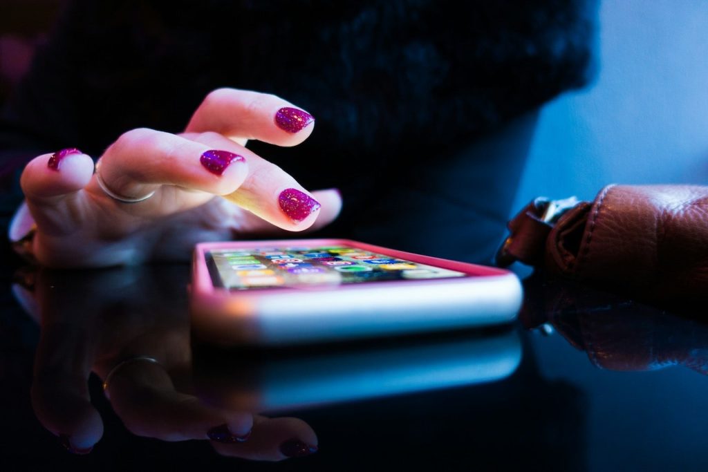 persons-hand-texting-smartphone.jpeg